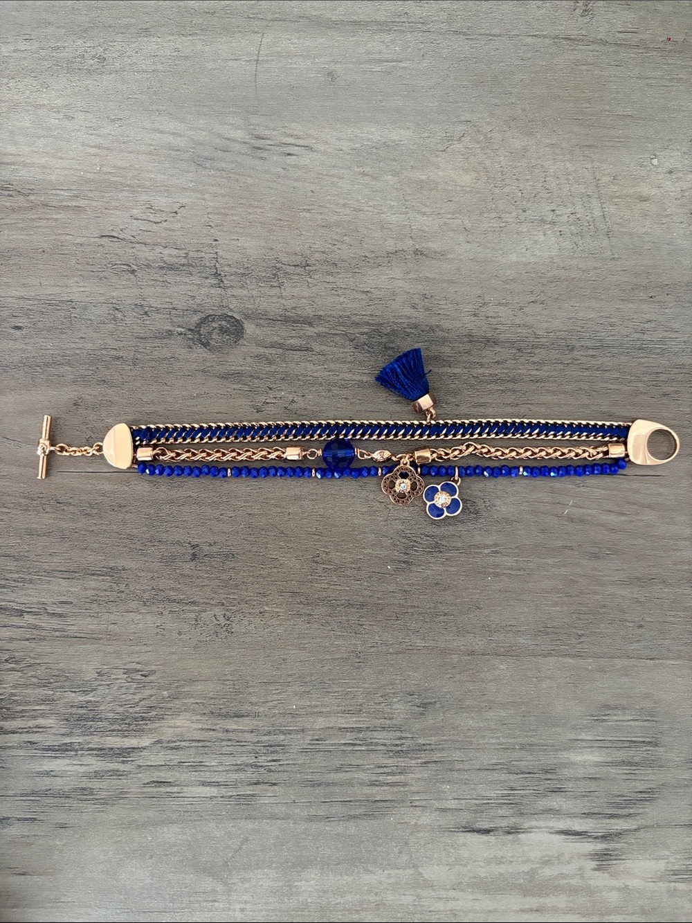 Henri Bendel bracelet with floral medallions, tassel and blue beads